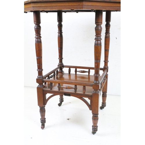 592 - Early 20th century Walnut Octagonal Table raised on turned legs united by an undershelf and raised o... 