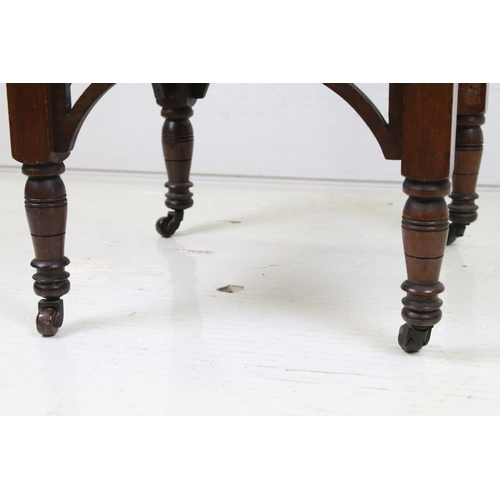 592 - Early 20th century Walnut Octagonal Table raised on turned legs united by an undershelf and raised o... 