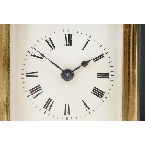 211 - A French brass cased carriage clock with beveled glass panels.