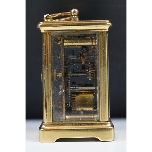 211 - A French brass cased carriage clock with beveled glass panels.