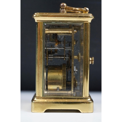 211 - A French brass cased carriage clock with beveled glass panels.