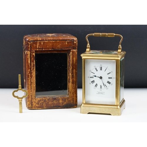 222 - An antique French brass cased carriage clock with beveled glass panels, repeater button to top, reta... 