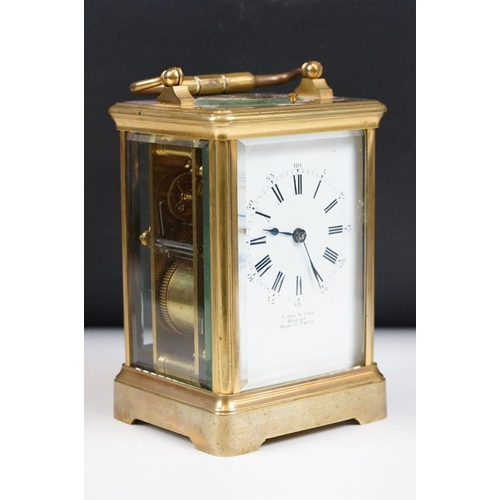 222 - An antique French brass cased carriage clock with beveled glass panels, repeater button to top, reta... 