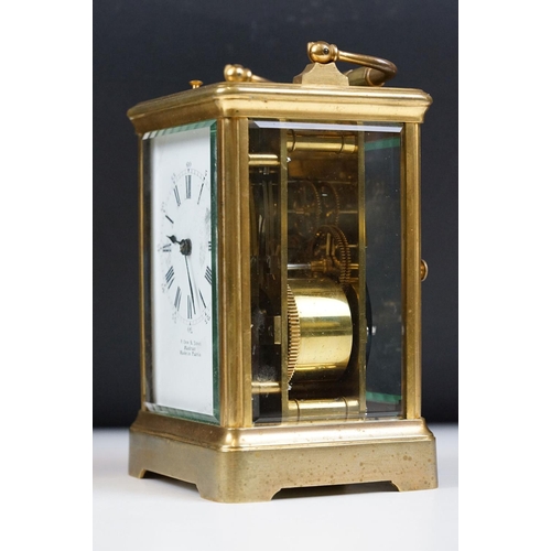 222 - An antique French brass cased carriage clock with beveled glass panels, repeater button to top, reta... 