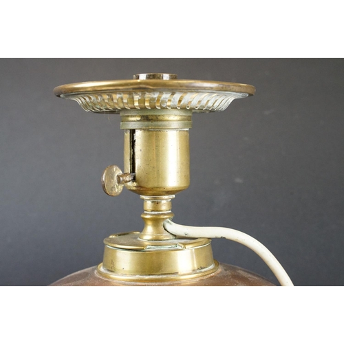 125 - W.A.S. Benson Arts & Craft oil lamp, with a copper font over a brass tri-form base with paw & ball f... 