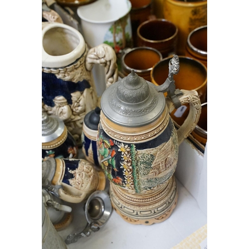 99 - Collection of assorted German beer steins to include musical examples. Tallest measures 27cm tall. T... 