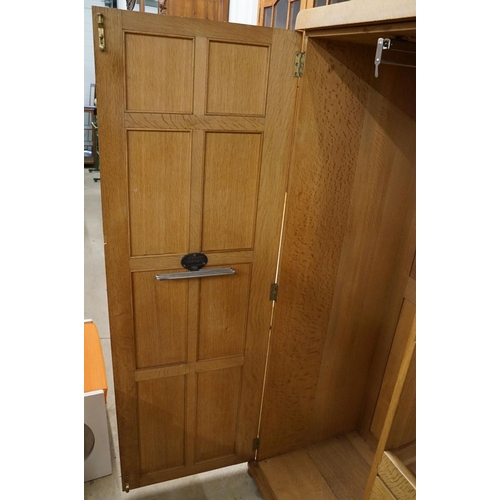 669 - Arts and Crafts ' Heal and Son ' Limed Oak Wardrobe, the two panel doors opening to an interior fitt... 