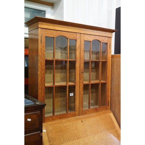 670 - Arts and Crafts ' Heal & Son ' Oak Bureau Bookcase, the upper section with two glazed doors opening ... 