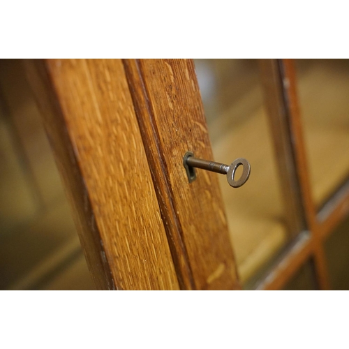 670 - Arts and Crafts ' Heal & Son ' Oak Bureau Bookcase, the upper section with two glazed doors opening ... 