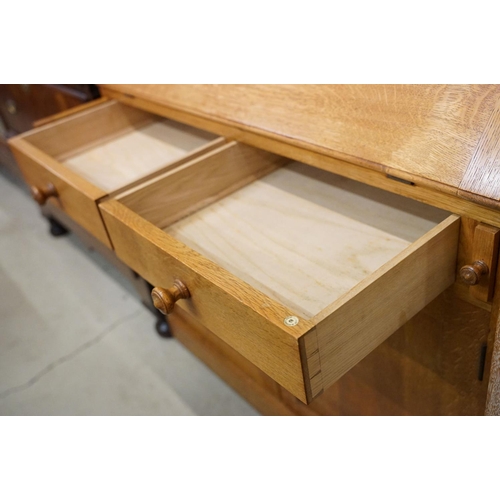 670 - Arts and Crafts ' Heal & Son ' Oak Bureau Bookcase, the upper section with two glazed doors opening ... 