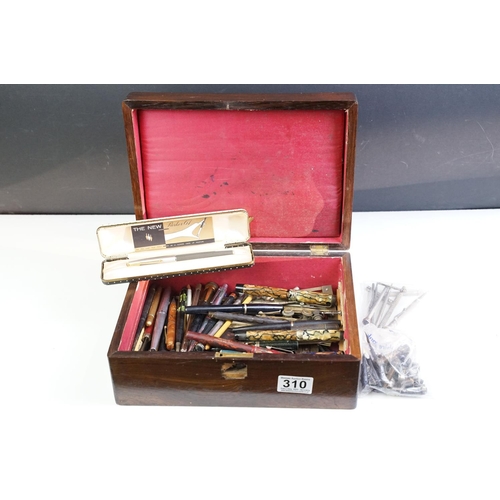 310 - A collection of mixed pens and pencils to include Parker & Waterman fountain pens together with othe... 