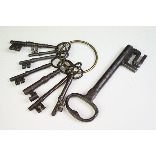 320 - A collection of eight antique cast iron keys.