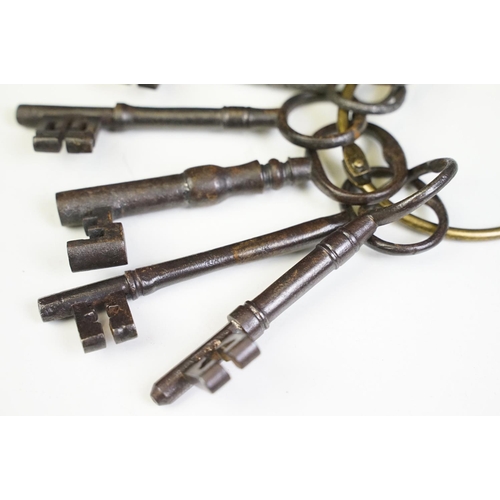 320 - A collection of eight antique cast iron keys.