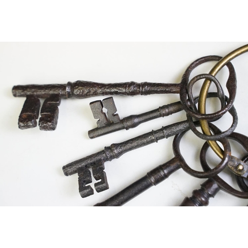 320 - A collection of eight antique cast iron keys.