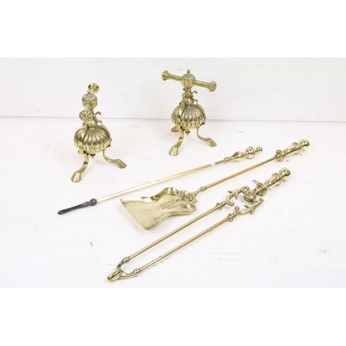 404 - An antique brass fireside companion set to include tongs, shovel and poker together with two piece s... 