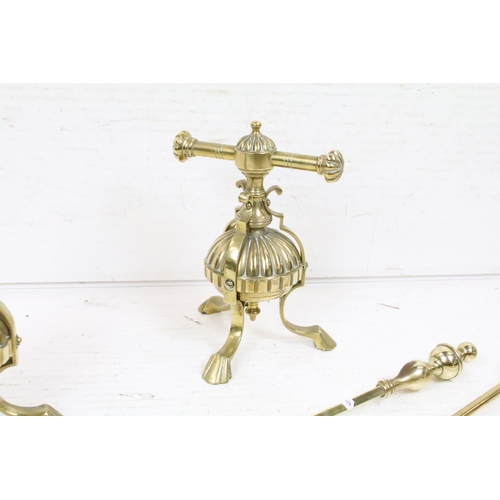 404 - An antique brass fireside companion set to include tongs, shovel and poker together with two piece s... 