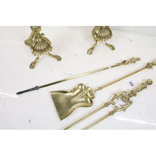 404 - An antique brass fireside companion set to include tongs, shovel and poker together with two piece s... 