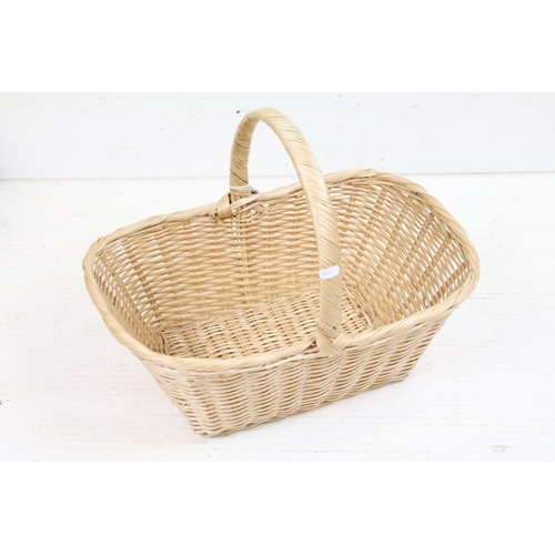 379 - Wicker stair basket with loop handle, together with a further wicker basket (51cm long), and a twin-... 