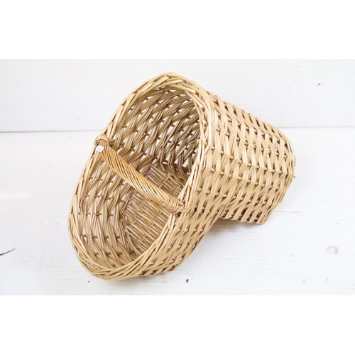 379 - Wicker stair basket with loop handle, together with a further wicker basket (51cm long), and a twin-... 