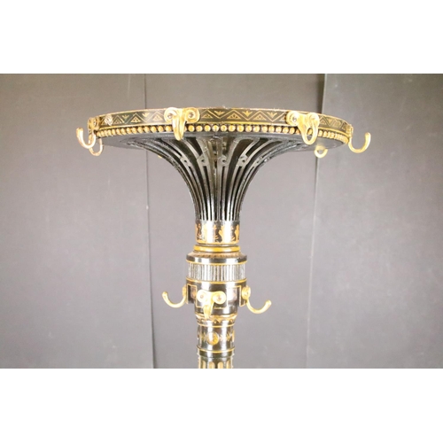 641 - 19th century Ebonised and Gilt Revolving Circular Coat and Hat Stand, the top with eight brass hooks... 