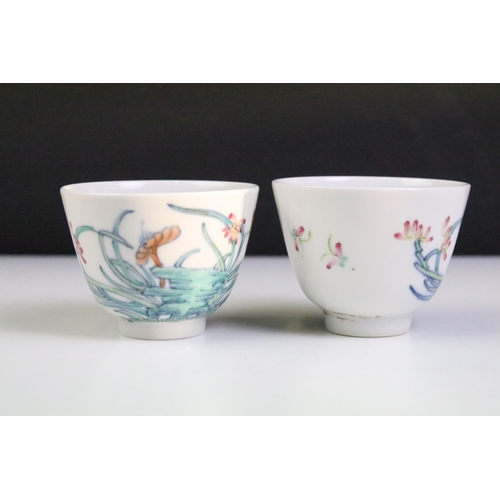 18A - Pair of Chinese porcelain tea bowls with enamel floral & insect decoration, six-character marks to b... 