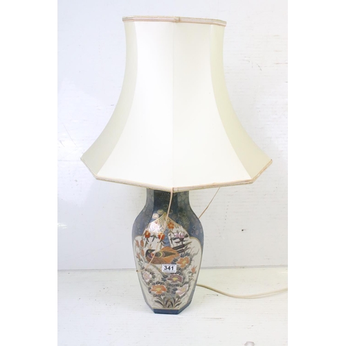 341 - A ceramic oriental style table lamp together with two silver plated candlesticks.