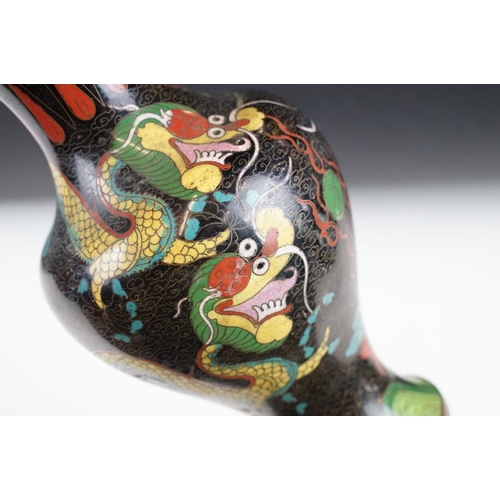 138 - Chinese cloisonne enamelled vase having a back ground with Chinese dragon detailing. Measures 26.5cm... 