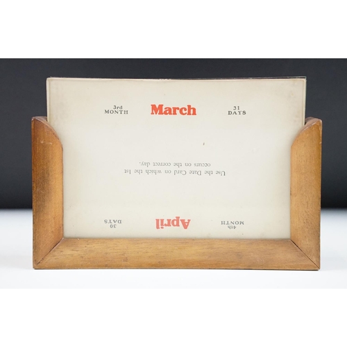 143 - Art Deco Perpetual Calendar set within a Wooden Frame, 17cm wide