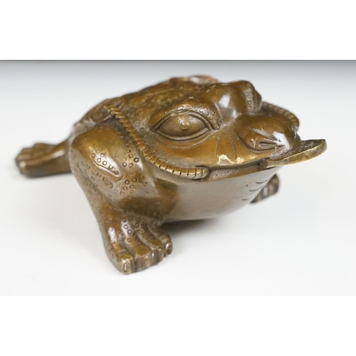 148 - Cast metal Chinese lucky money toad modelled with three legs with moulded detailing and coin to the ... 