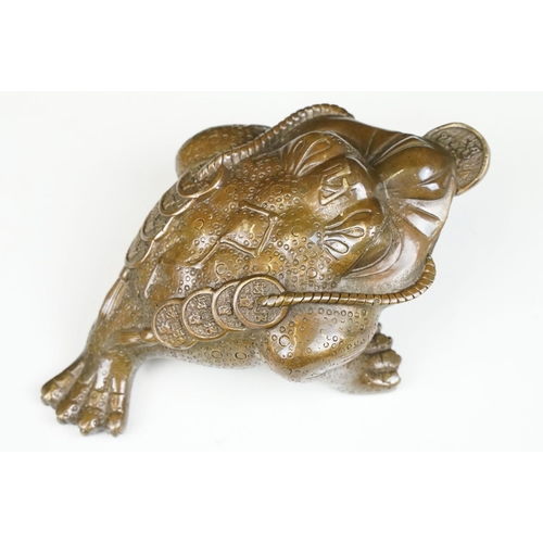 148 - Cast metal Chinese lucky money toad modelled with three legs with moulded detailing and coin to the ... 