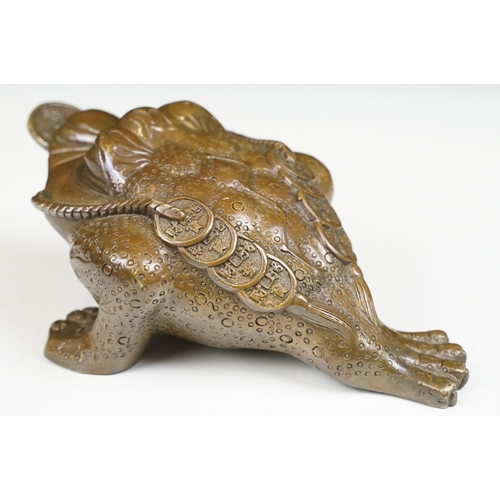 148 - Cast metal Chinese lucky money toad modelled with three legs with moulded detailing and coin to the ... 