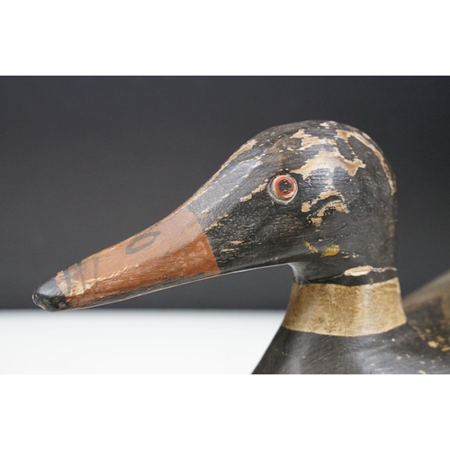 157 - Two early 20th Century carved and hand painted decoy ducks. Both unmarked, with flat bases. Measures... 