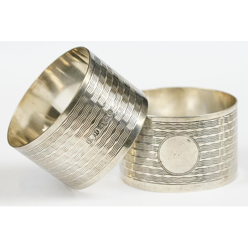 198 - A pair of fully hallmarked sterling silver napkin rings with engine turned decoration, Birmingham 19... 