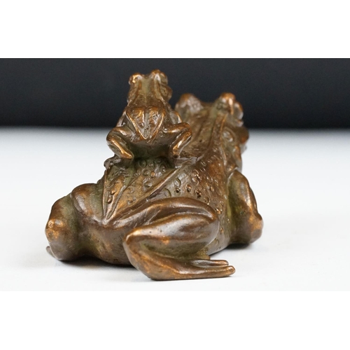 204 - An ornamental Chinese copper figure of a toad carrying a smalller toad.