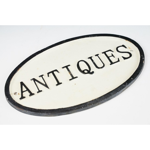 128 - Cast Iron Oval ‘ Antiques ‘ Sign, 34cm long