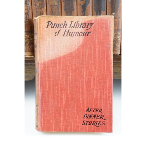 131 - Set of 25 ' Punch Library of Humour ' books, housed on a wooden book trough, approx 64cm wide