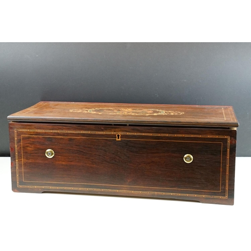 135 - 19th Century Six-air Swiss music box, the marquetry inlaid rosewood case opening to a 34.5cm brass c... 