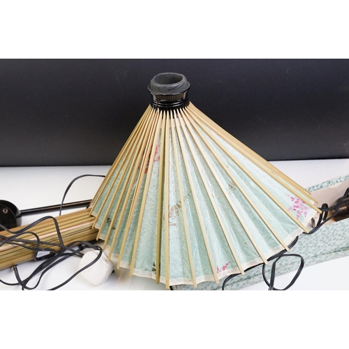 369 - Pair of Oriental standard lamps with fan / lantern paper shades, each raised on three black lacquere... 