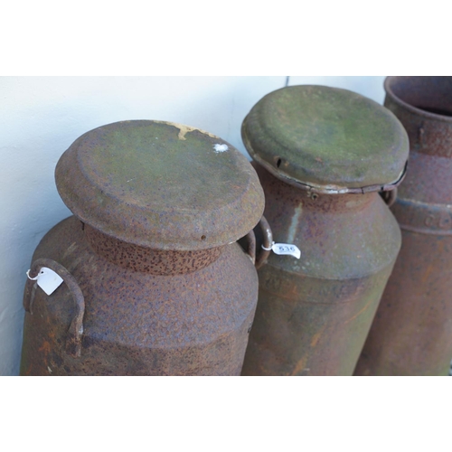 536 - Collection of four steel milk churns of typical form, two with lids. Measure approx 75cm tall