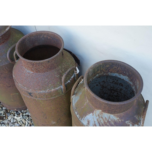 536 - Collection of four steel milk churns of typical form, two with lids. Measure approx 75cm tall