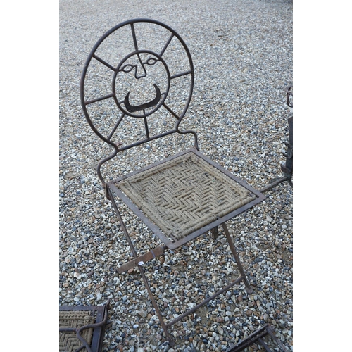 537 - Three cast iron folding chairs with stylised face to back and woven seats, together with a pair of r... 