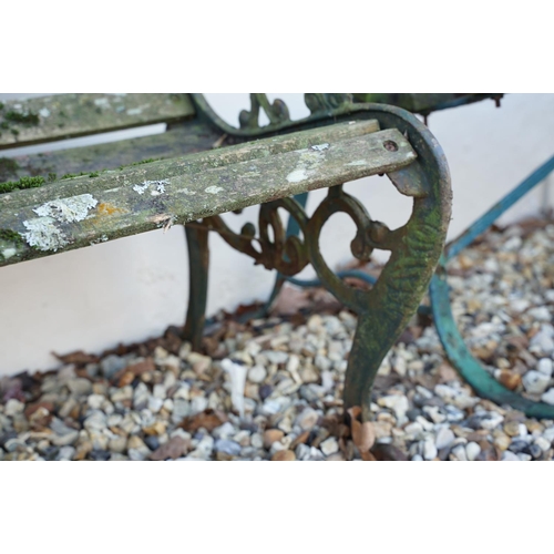 539 - Wooden slatted garden bench, the cast iron ends with lion mask features, approx 125cm wide