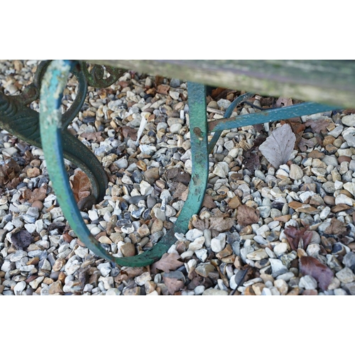 540 - Wooden slatted garden bench with wrought iron scrolling ends, approx 150cm wide