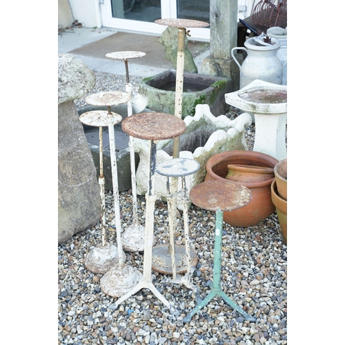 546 - Collection of seven painted iron adjustable pot stands of varying height & form