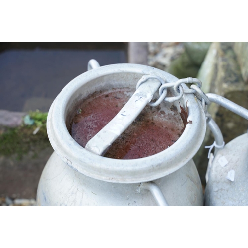 549 - Two aluminium milk churns, twin-handled, of typical form, approx 53cm high