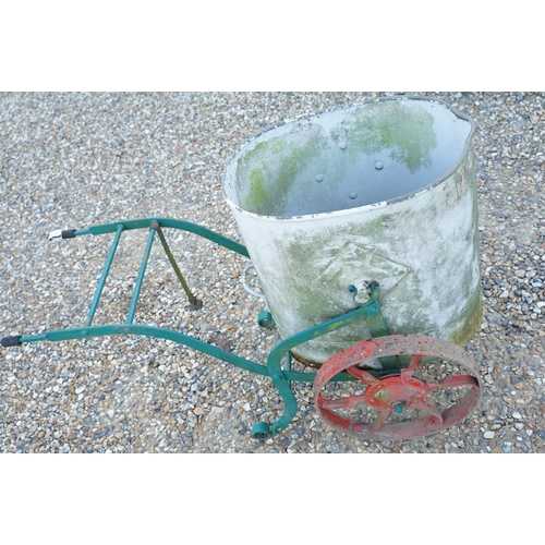 561 - Wrought iron trolley on cast iron wheels, with steel bucket, measures approx 120cm long