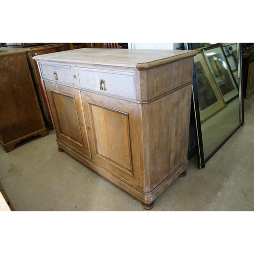 586 - Early 20th century Limed Oak Side Cabinet with two drawers over two cupboard doors, raised on squat ... 