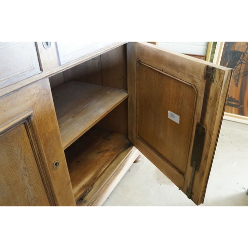 586 - Early 20th century Limed Oak Side Cabinet with two drawers over two cupboard doors, raised on squat ... 