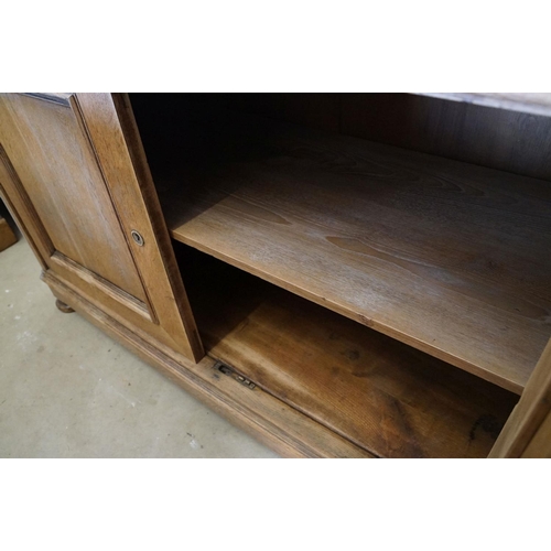 586 - Early 20th century Limed Oak Side Cabinet with two drawers over two cupboard doors, raised on squat ... 