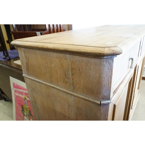 586 - Early 20th century Limed Oak Side Cabinet with two drawers over two cupboard doors, raised on squat ... 